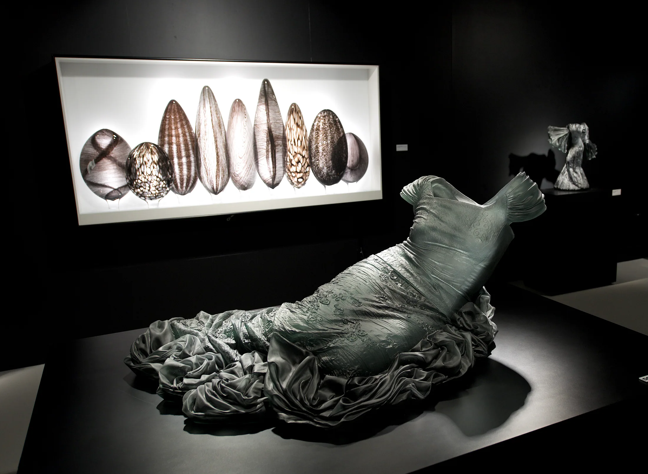 Glass dress sculpture displayed in an Imagine Museum gallery